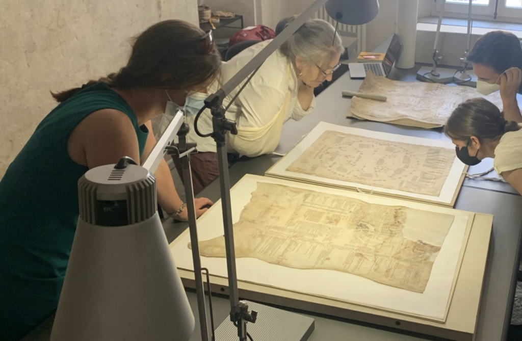 People reading manuscripts.